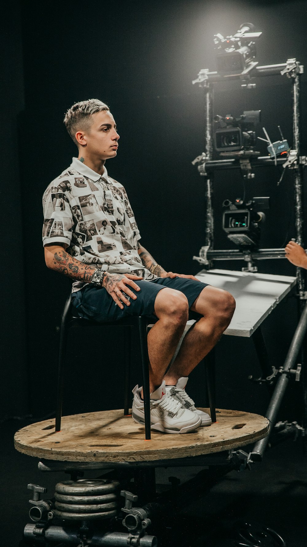 a man sitting on a chair in front of a camera