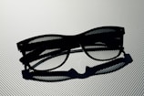 A close-up of elegant sunglasses resting on a marble surface.