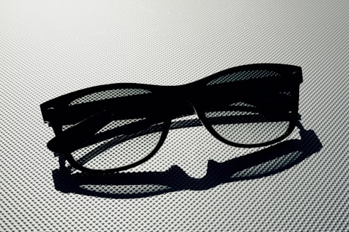 A close-up of elegant sunglasses resting on a marble surface.