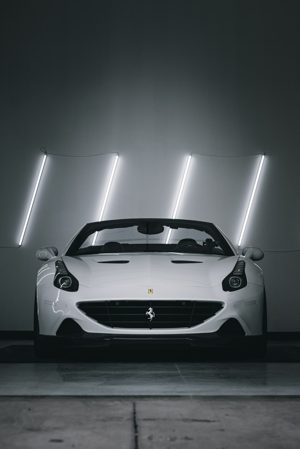 a white sports car parked in a garage