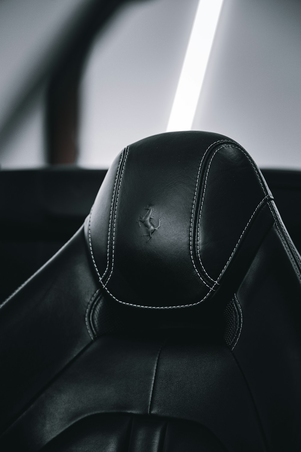 a close up of a black leather seat in a car