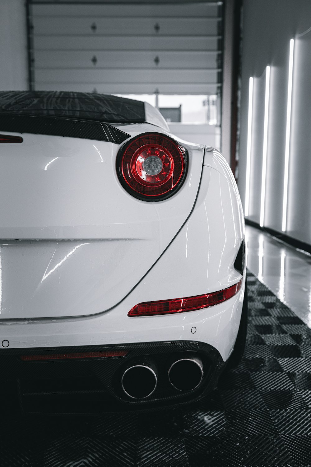 a white sports car parked in a garage