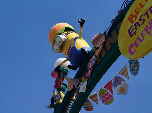 A whimsical no parking sign painted in cheerful Easter hues with playful decorations.