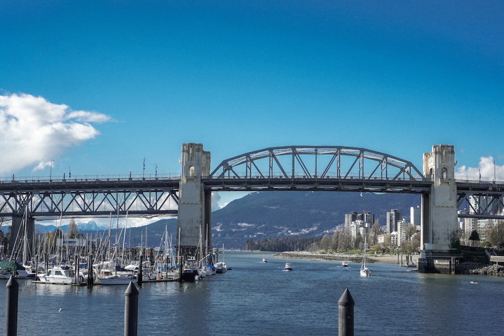 a bridge over a body of water with boats in it