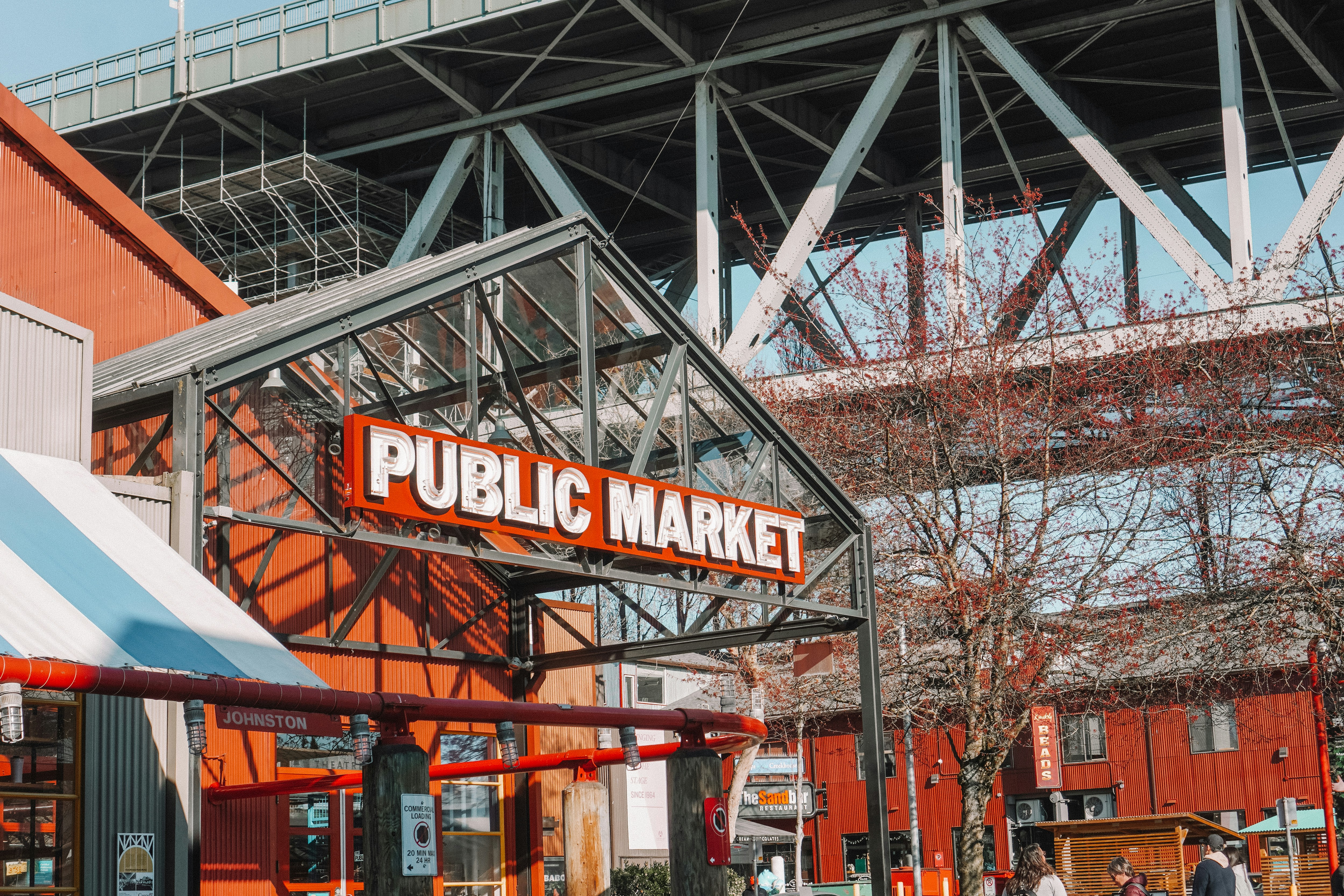 a public market with people walking around it