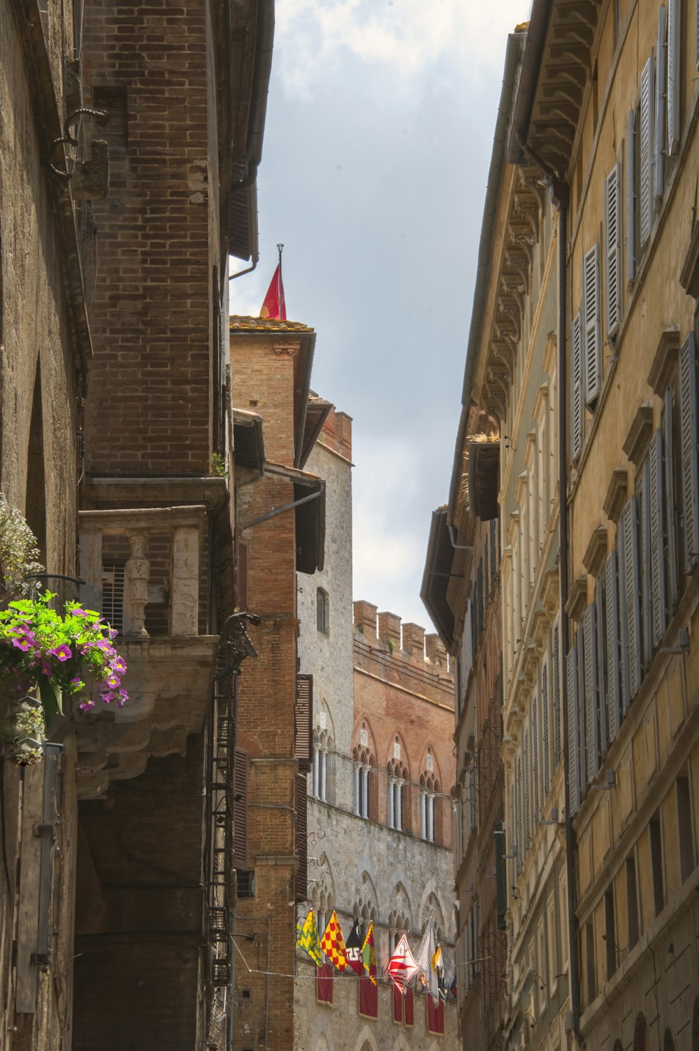 a narrow city street with buildings on both sides