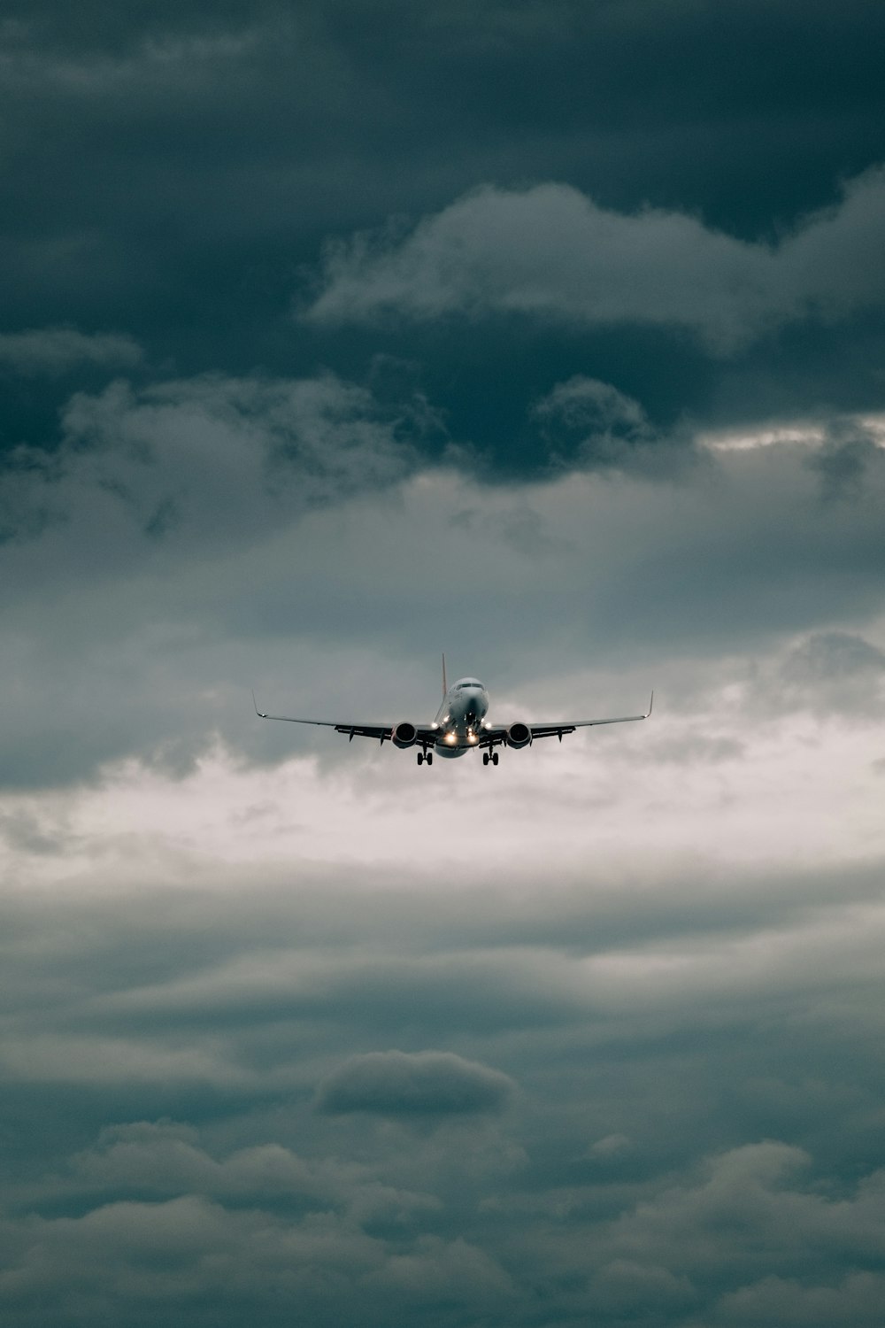 a large jetliner flying through a cloudy sky