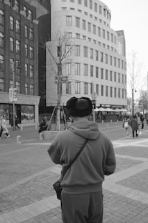 A sleek modern cap with minimalist design worn by a person walking in the city