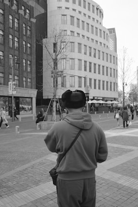 A sleek modern cap with minimalist design worn by a person walking in the city