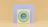 A minimalist composition featuring geometric shapes with a pastel color palette. In the foreground is a square structure with a circular, green-bordered element resembling a speaker or lens. The backdrop consists of a soft purple rectangle set against a warm beige background.