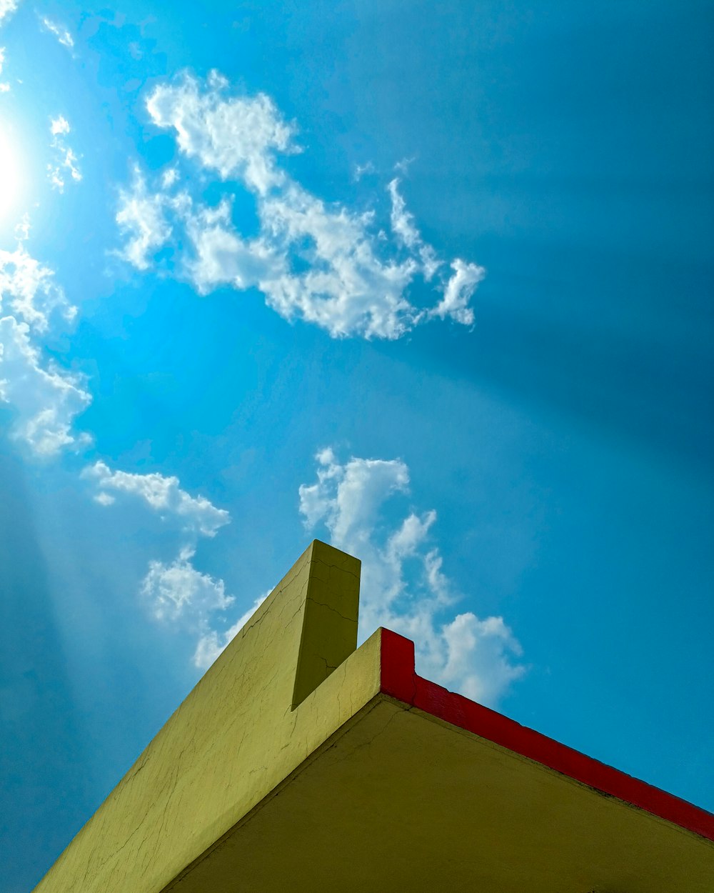 the sun shines brightly through the clouds above a building