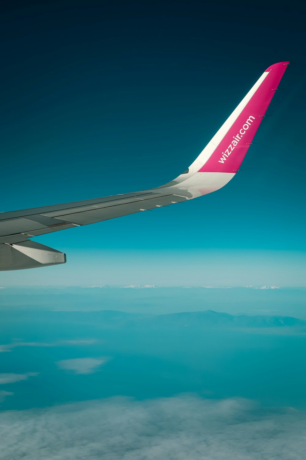 a view of the wing of an airplane in the sky