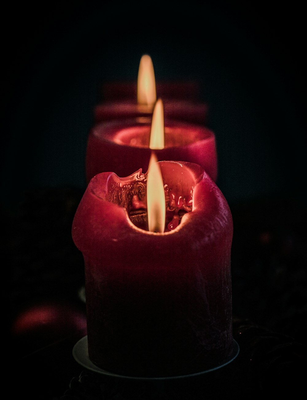 Una hilera de velas encendidas sentadas encima de una mesa