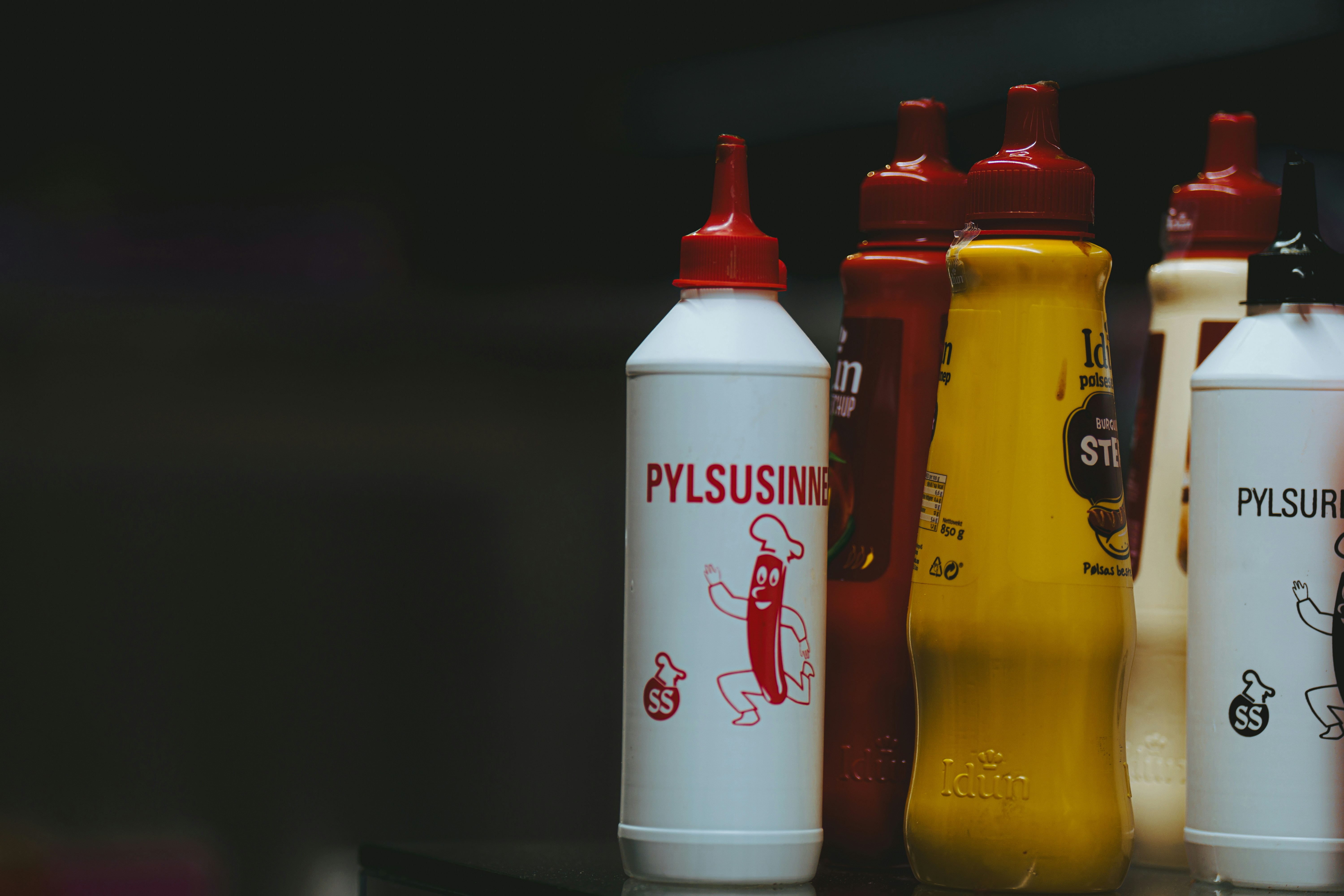 a row of plastic bottles sitting on top of a table, 
