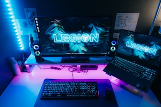 a desk with a laptop and a monitor on it