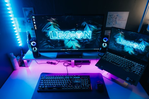 a desk with a laptop and a monitor on it