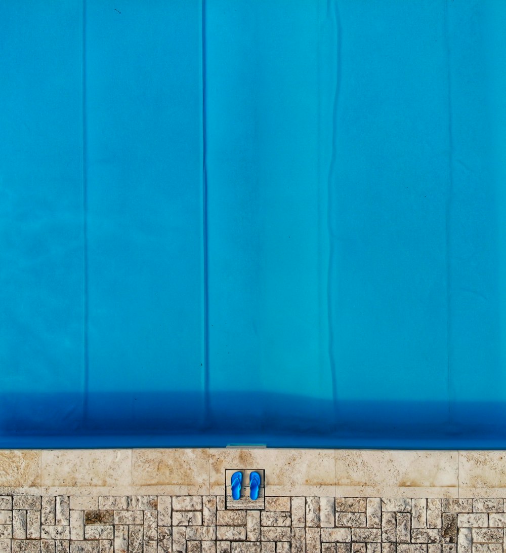 a tiled wall with a blue cover over it