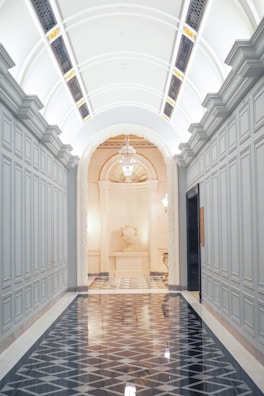 Elegant hallway with deep navy walls demonstrating impeccable coverage without brush marks.