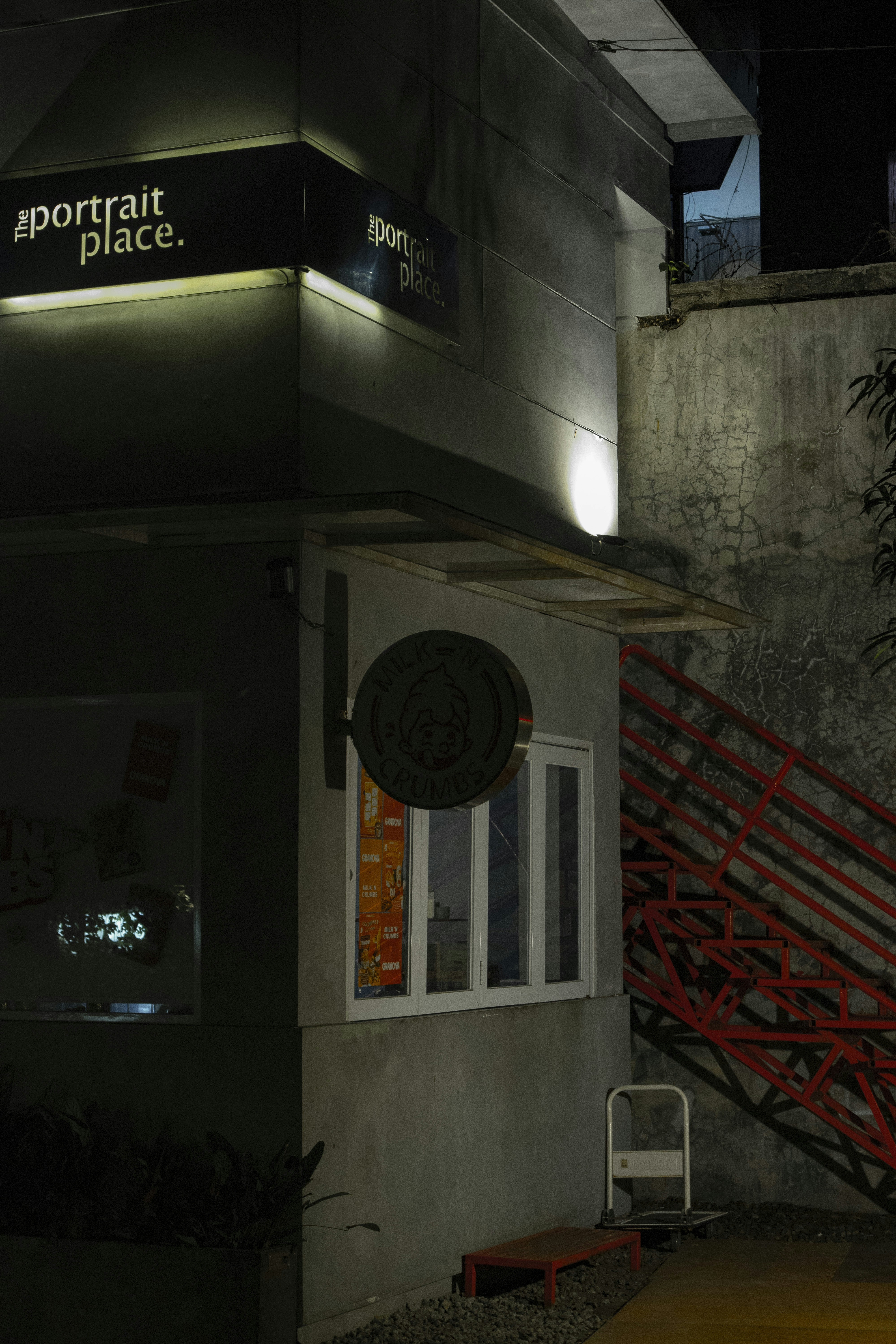 a building with a red stair case next to it