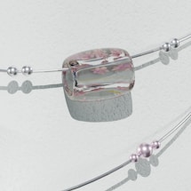 A delicate bracelet with two parallel silver wires adorned with multiple spherical beads and an elliptical, transparent centerpiece. The centerpiece features embedded pink floral motifs, adding elegance to the design. The beads vary in size and some appear to have a subtle purple hue. The backdrop is a textured, pale surface casting soft shadows.