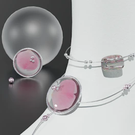 A set of delicate rhinestones and metal charms arranged artistically on a warm taupe background