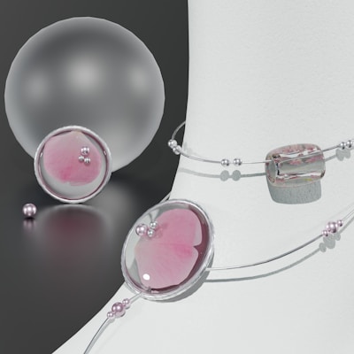Set of pastel-colored earrings and matching necklace arranged artistically on a marble slab