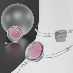 Delicate gold jewelry pieces styled with soft white and blush pink fabrics.