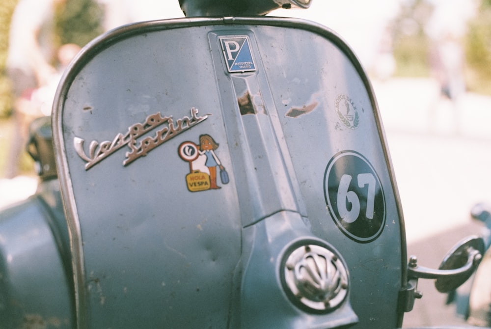 a close up of a motor scooter with stickers on it