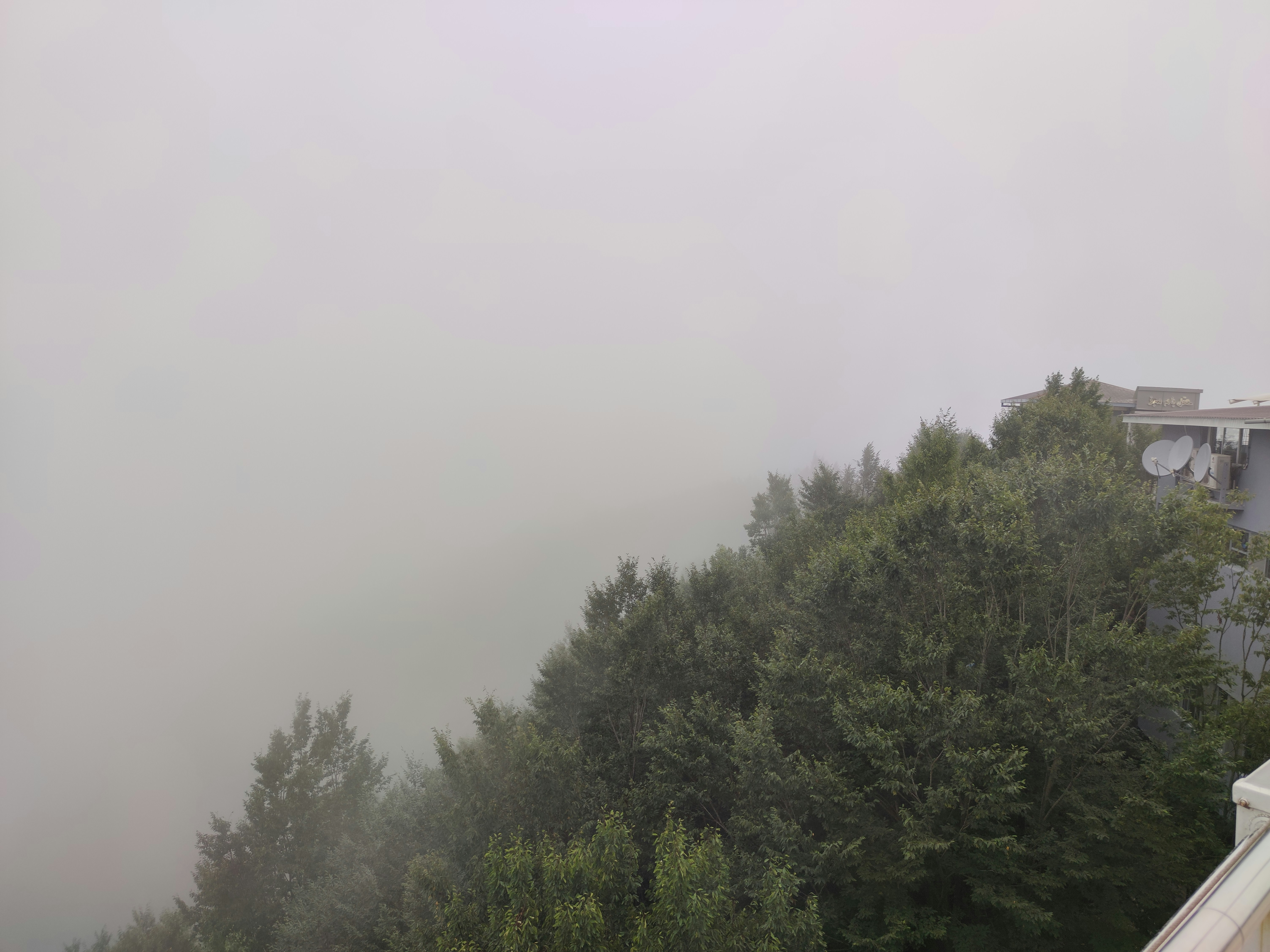 a foggy view of a house from a balcony