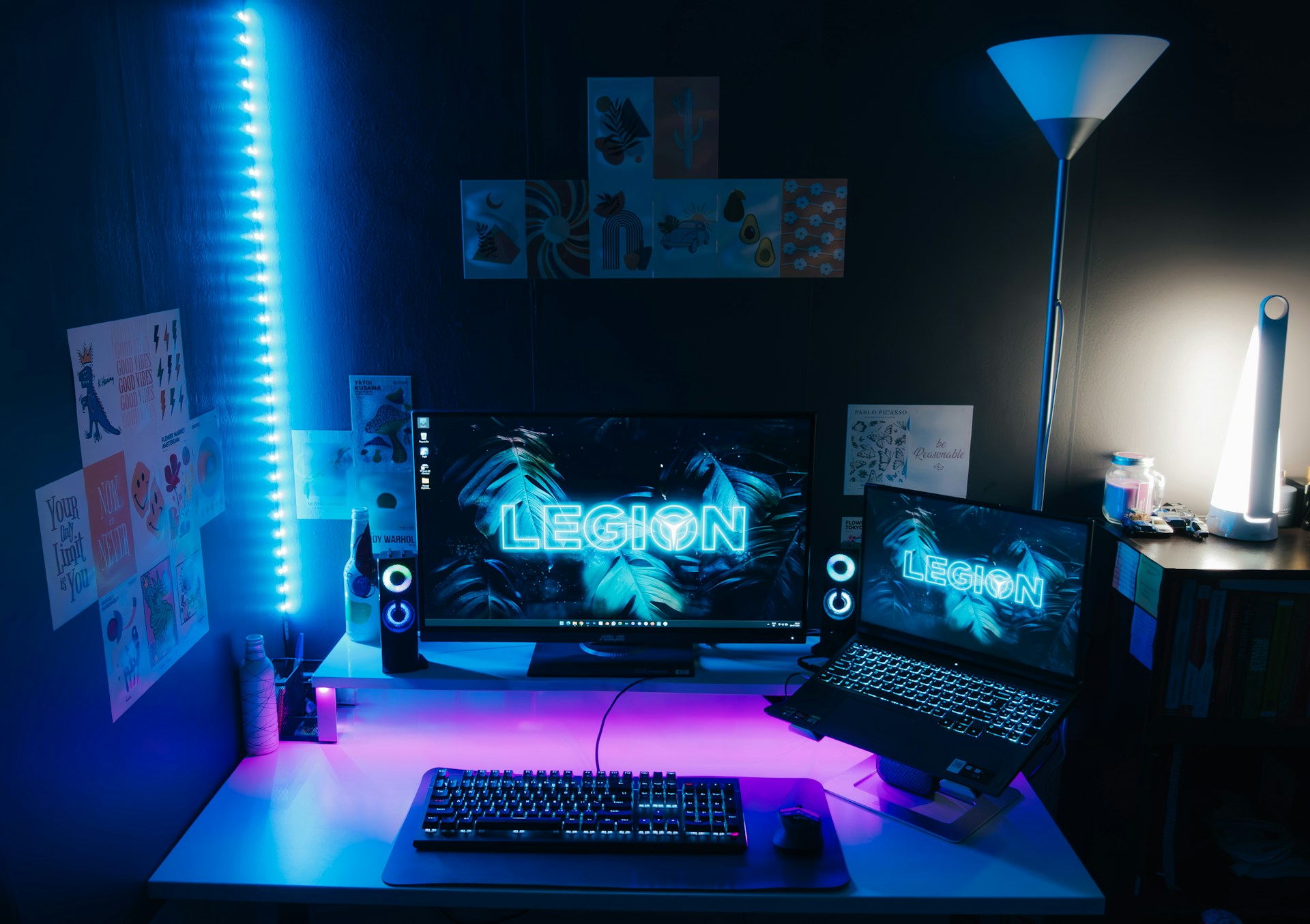 a desk with a laptop and a monitor on it