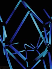 Abstract network of interconnected nodes glowing in electric blue on a deep charcoal background.