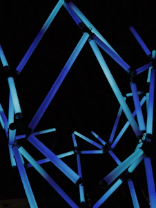 Abstract digital art showing glowing blue and white data lines forming a dynamic network around a stylized joint.