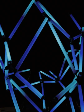 An abstract representation of interconnected nodes glowing with electric blue light.