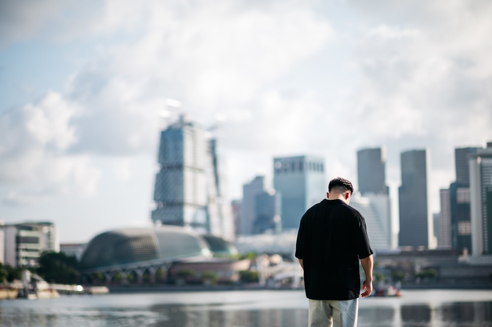 a man standing in front of a body of water