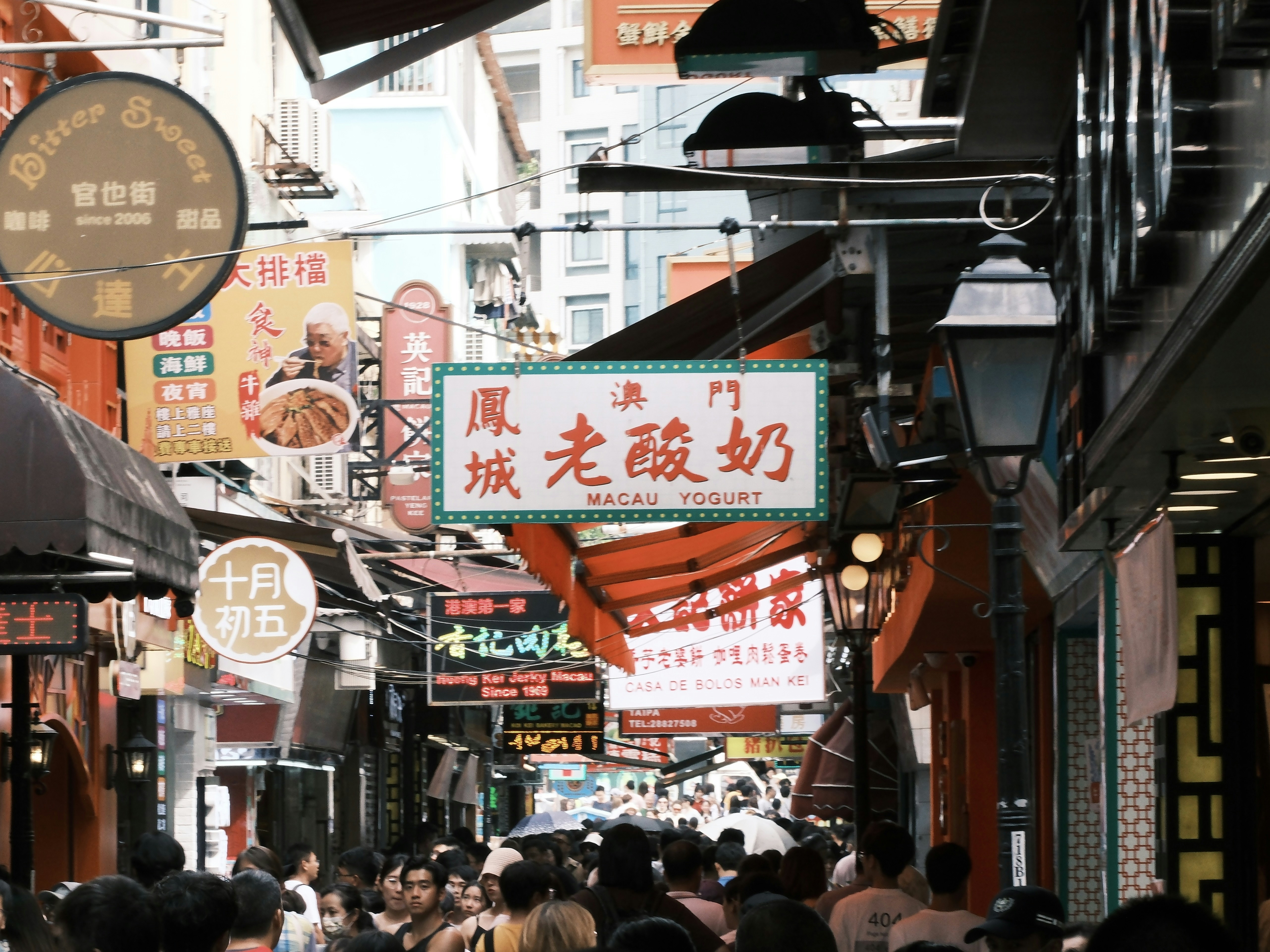 A vibrant street lined with various restaurants