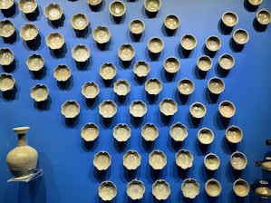 A beautifully arranged display of ceramic vases and tableware.