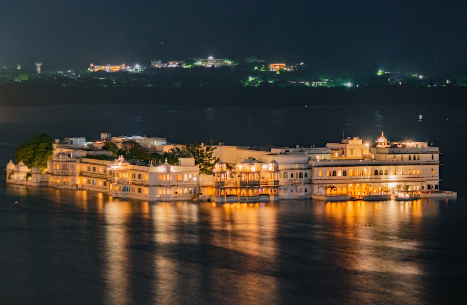 a large white building sitting on top of a body of water