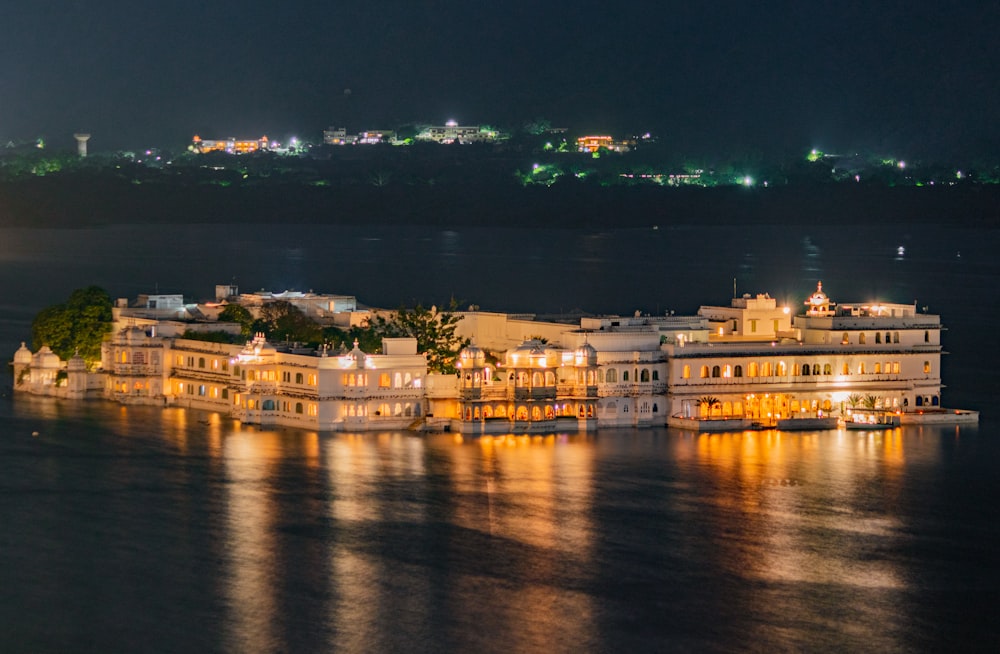 a large white building sitting on top of a body of water