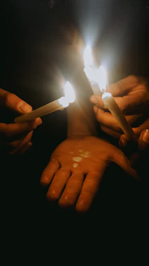 Hands carefully pouring wax into a candle mold in a bright, inviting workshop.