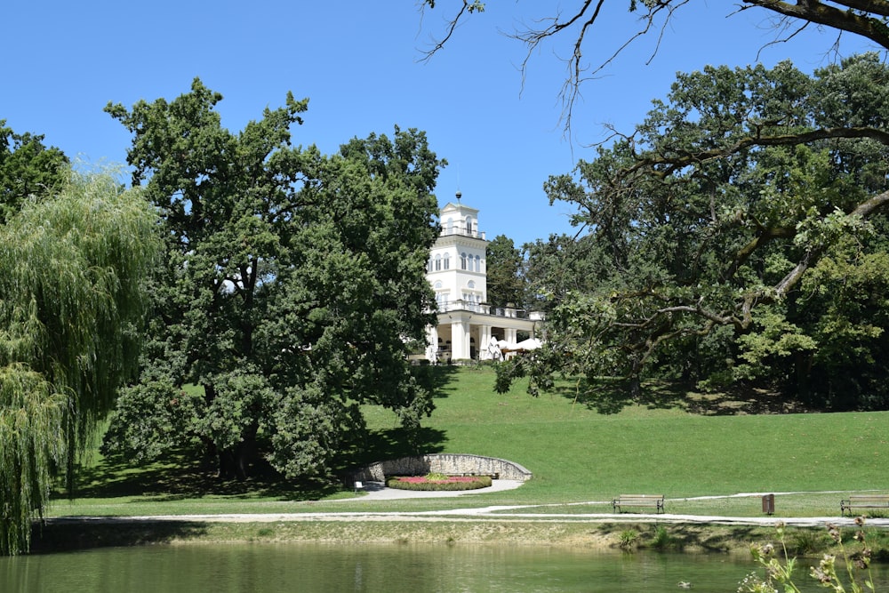 a large white house sitting on top of a lush green field