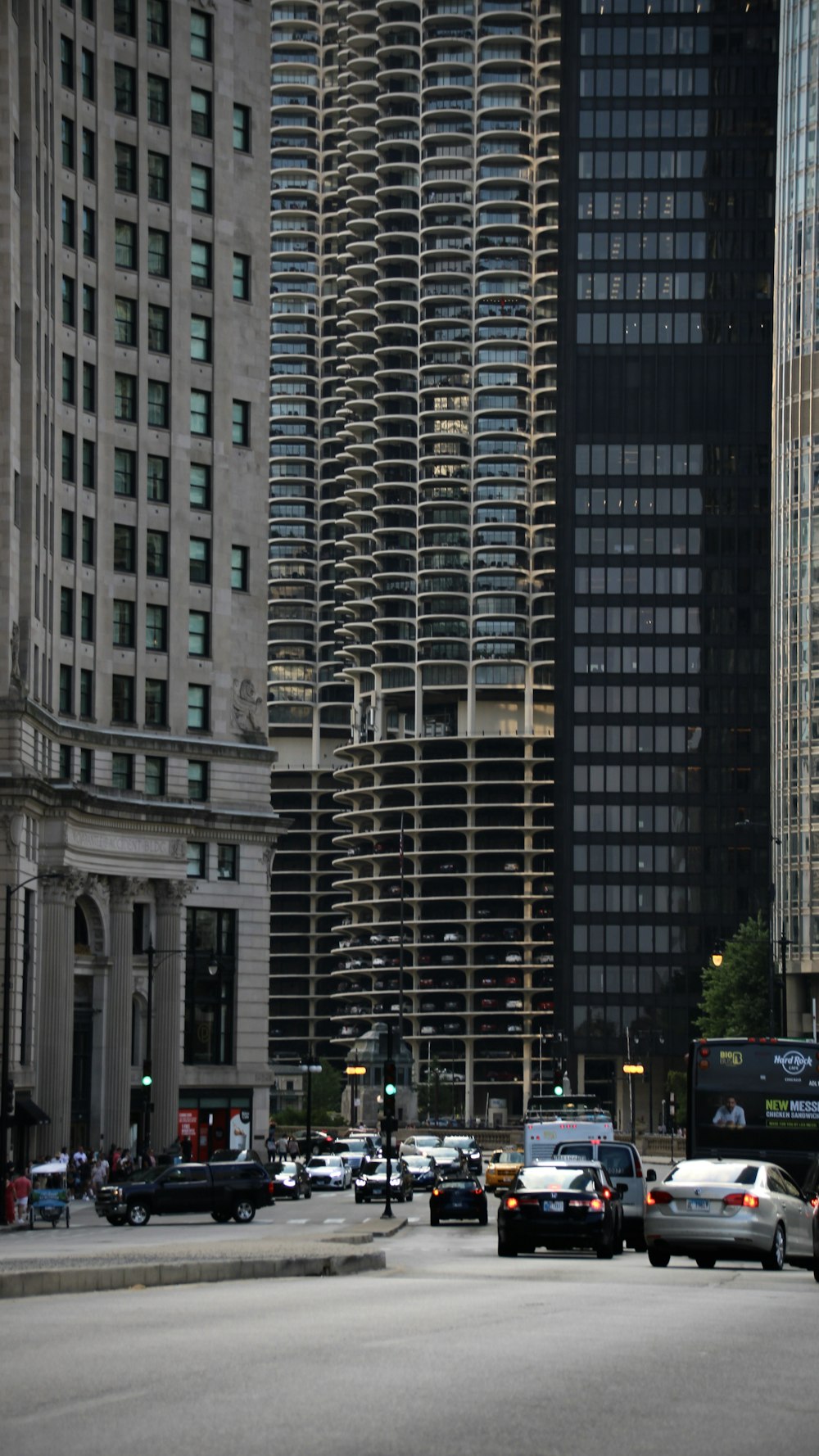 a city street filled with lots of traffic next to tall buildings