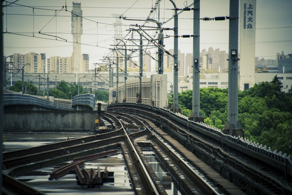 a train traveling down train tracks next to a city