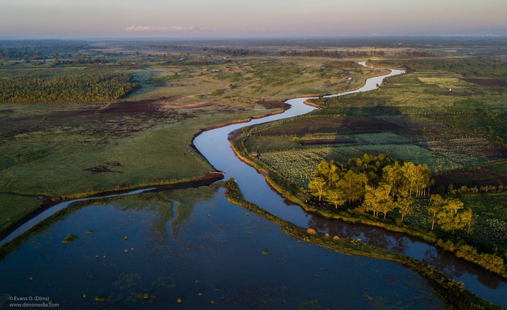 a river running through a lush green countryside