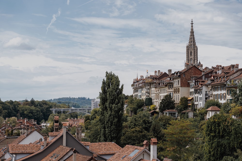 a view of a city with a church steeple in the background