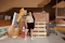 Photo of a cheerful woman inspecting bricks at a warehouse with shelves full of building materials.
