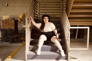 a woman sitting on top of a set of stairs