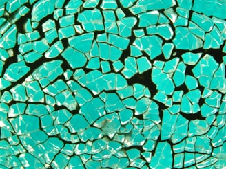 Close-up of a mosaic made from colorful broken pottery and sea glass, highlighting intricate details.