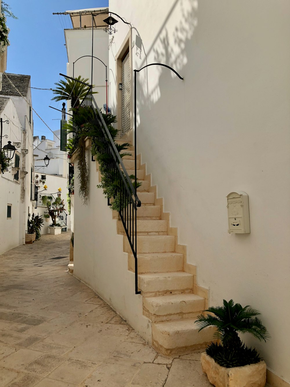 a white building with a stair case next to it