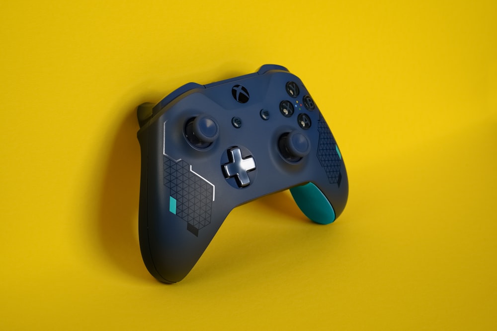 a close up of a controller on a yellow background