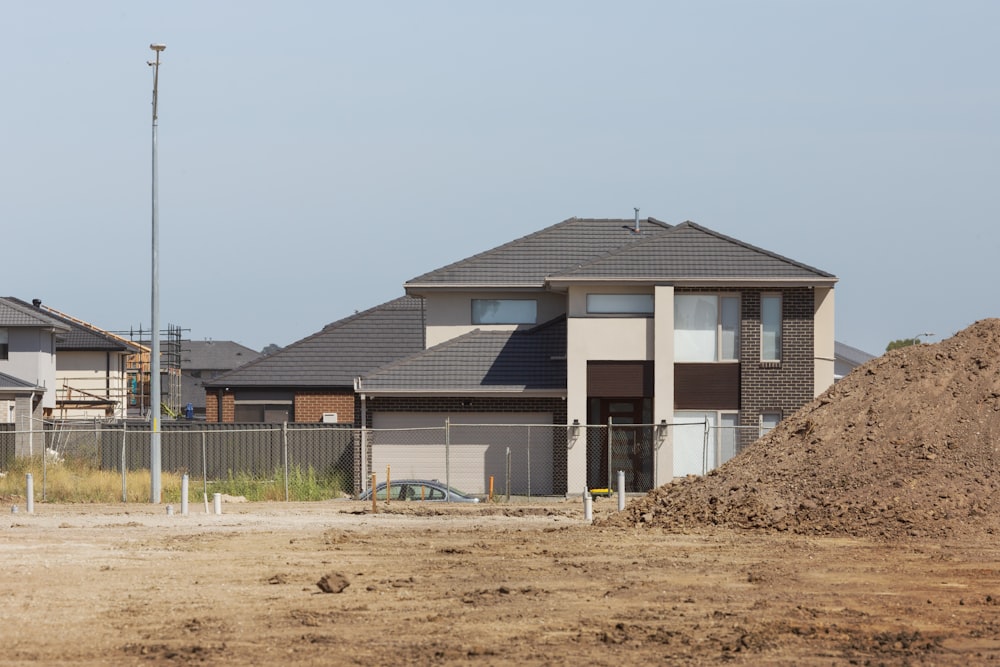 a large pile of dirt in front of a house